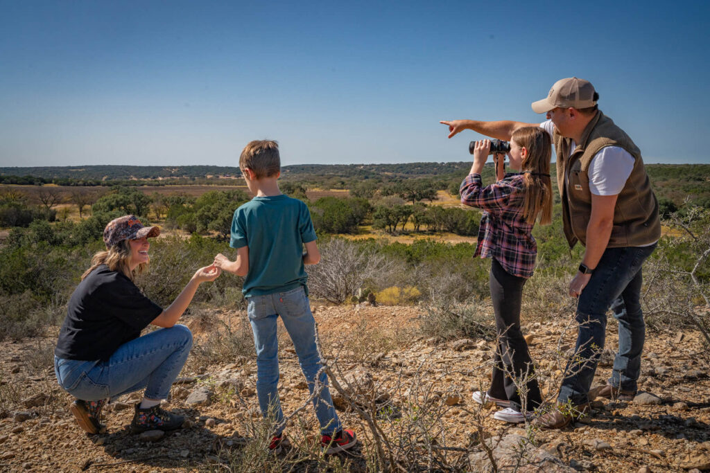family spotting wildlife and bird watching adventure in Hill Country