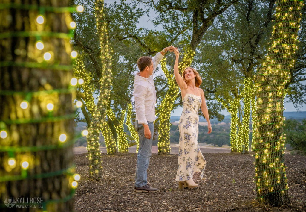 Just married romantic couple dancing under the oak trees at sunset