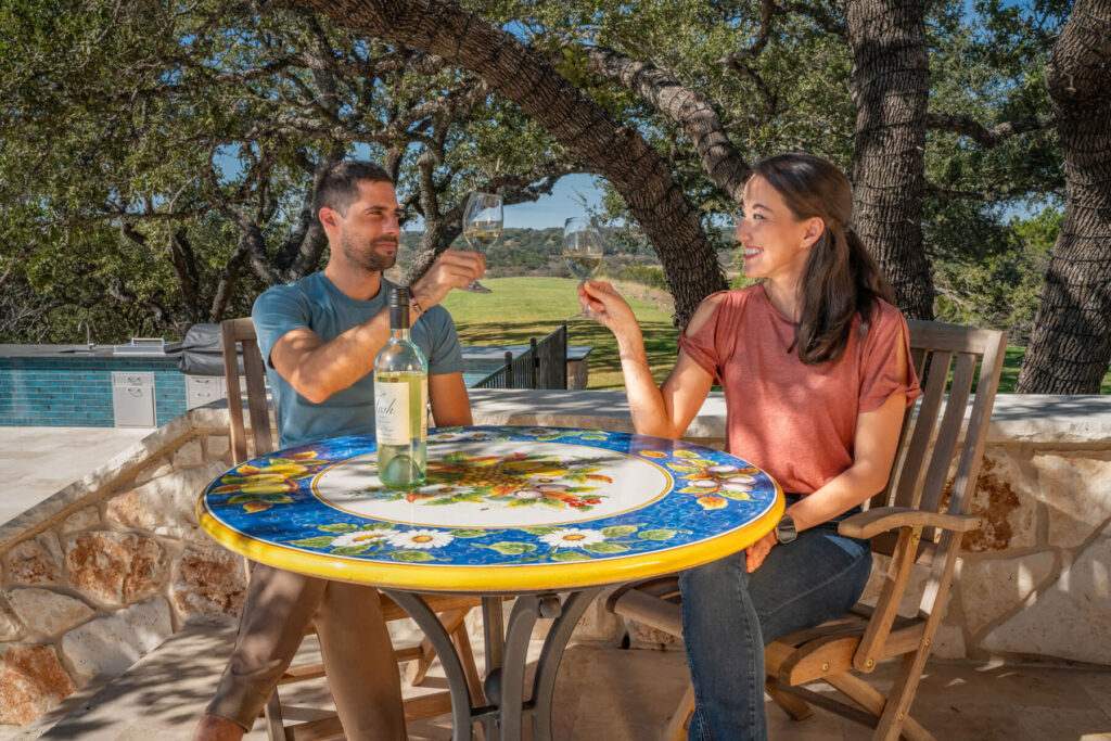 couple private wine tasting on the patio under the oaks