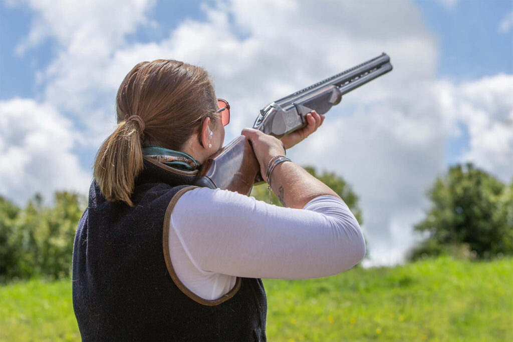 Woman trying clay sport shooting