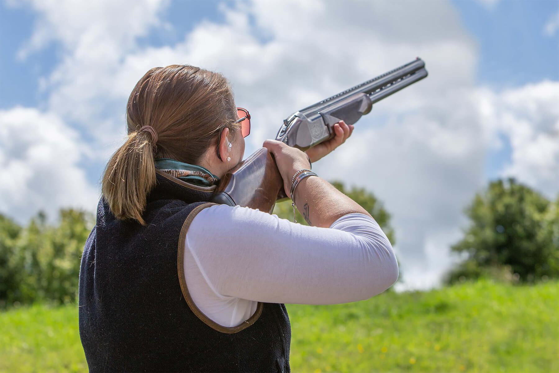 Woman trying clay sport shooting