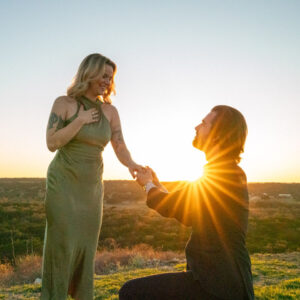 Sunset wedding proposal on the lawn overlooking beautiful view