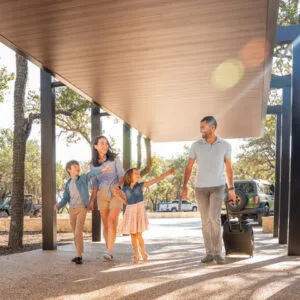Family arriving at the luxury ranch lodge for a family vacation