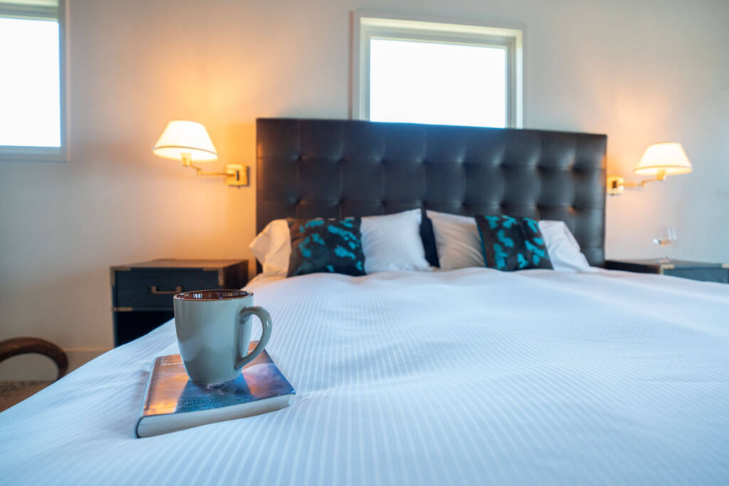 relaxing Coffee and a good book sitting on luxury linen bedspread in master guest suite king size bed