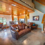 Bespoke and comfortable living room with leather couches and large-screen TV