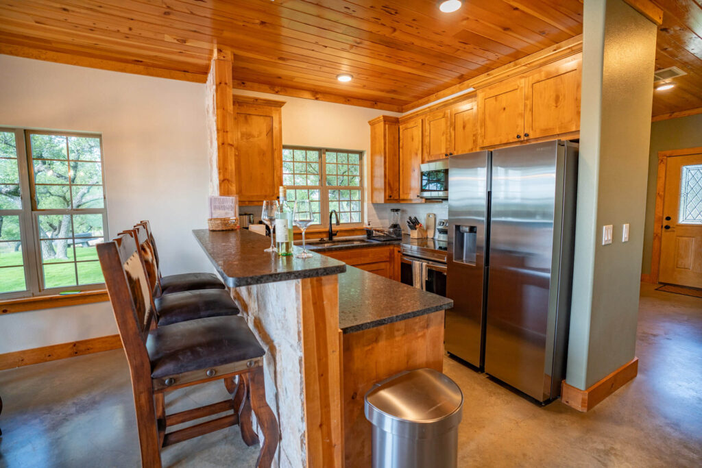 Complimentary wine and snacks on the kitchen counter at The Cottage