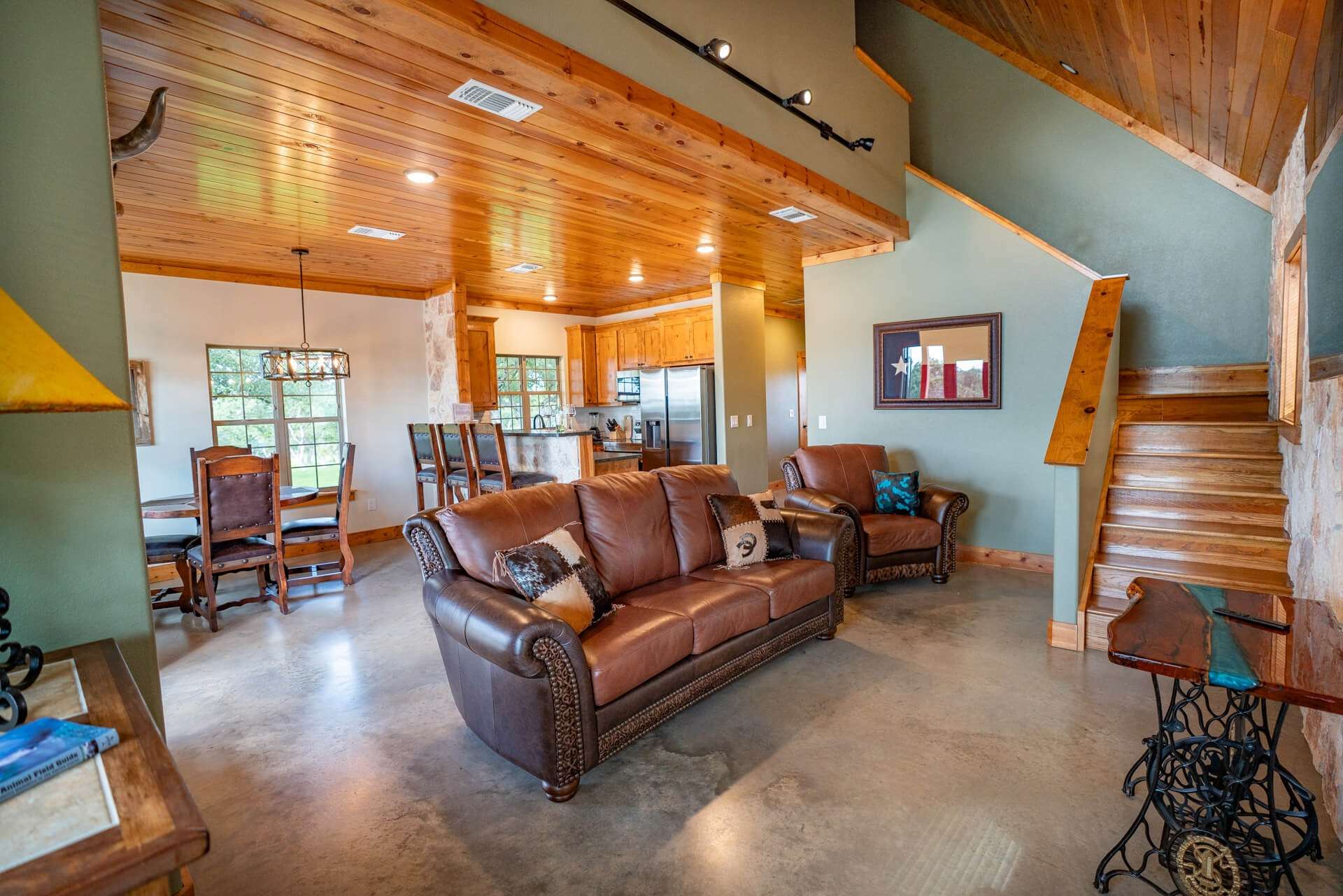 Artemis Cottage living room and dining area with leather sofa