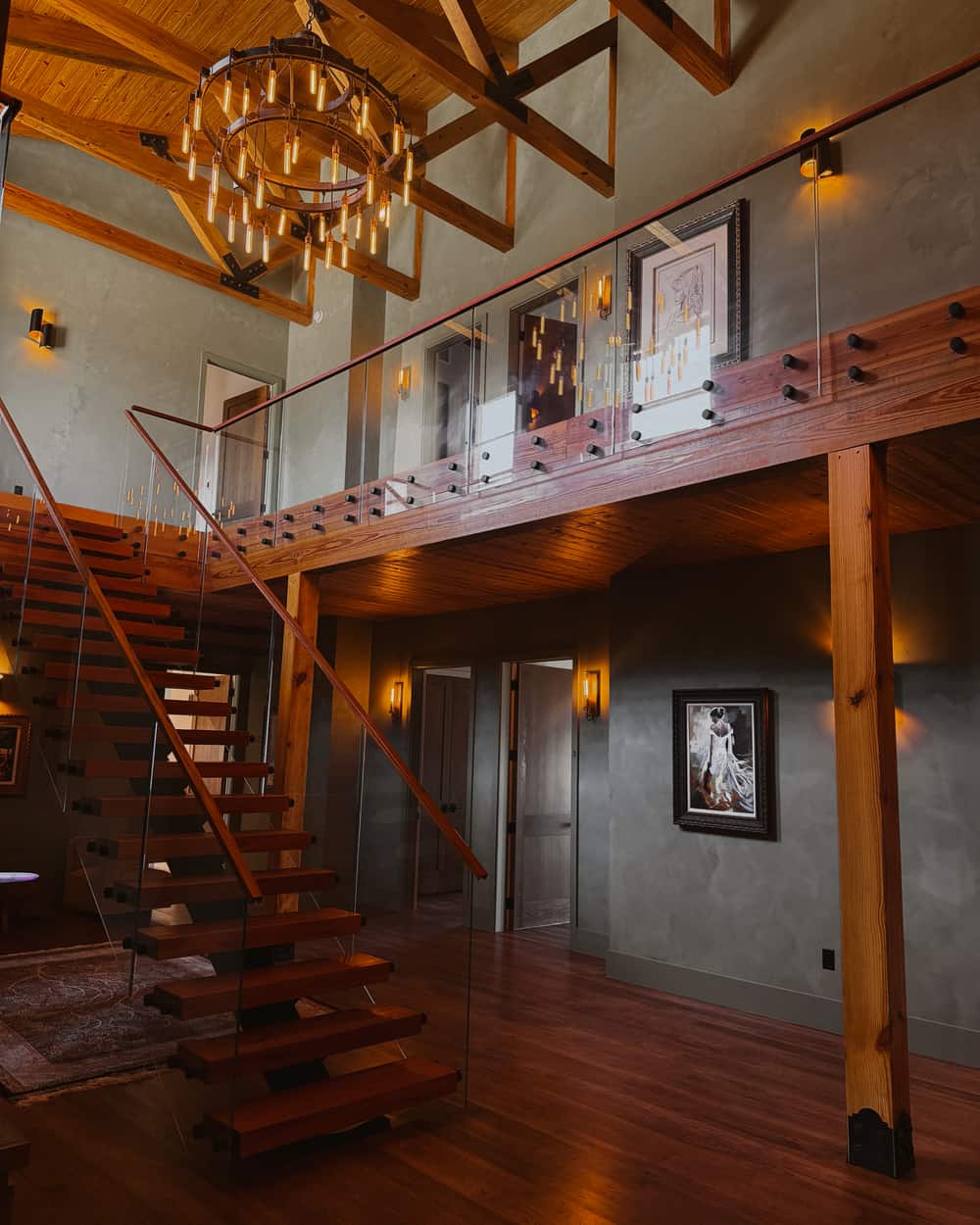 What to expect at Artemis Lodge - open stairway and loft with chandelier and timber beams