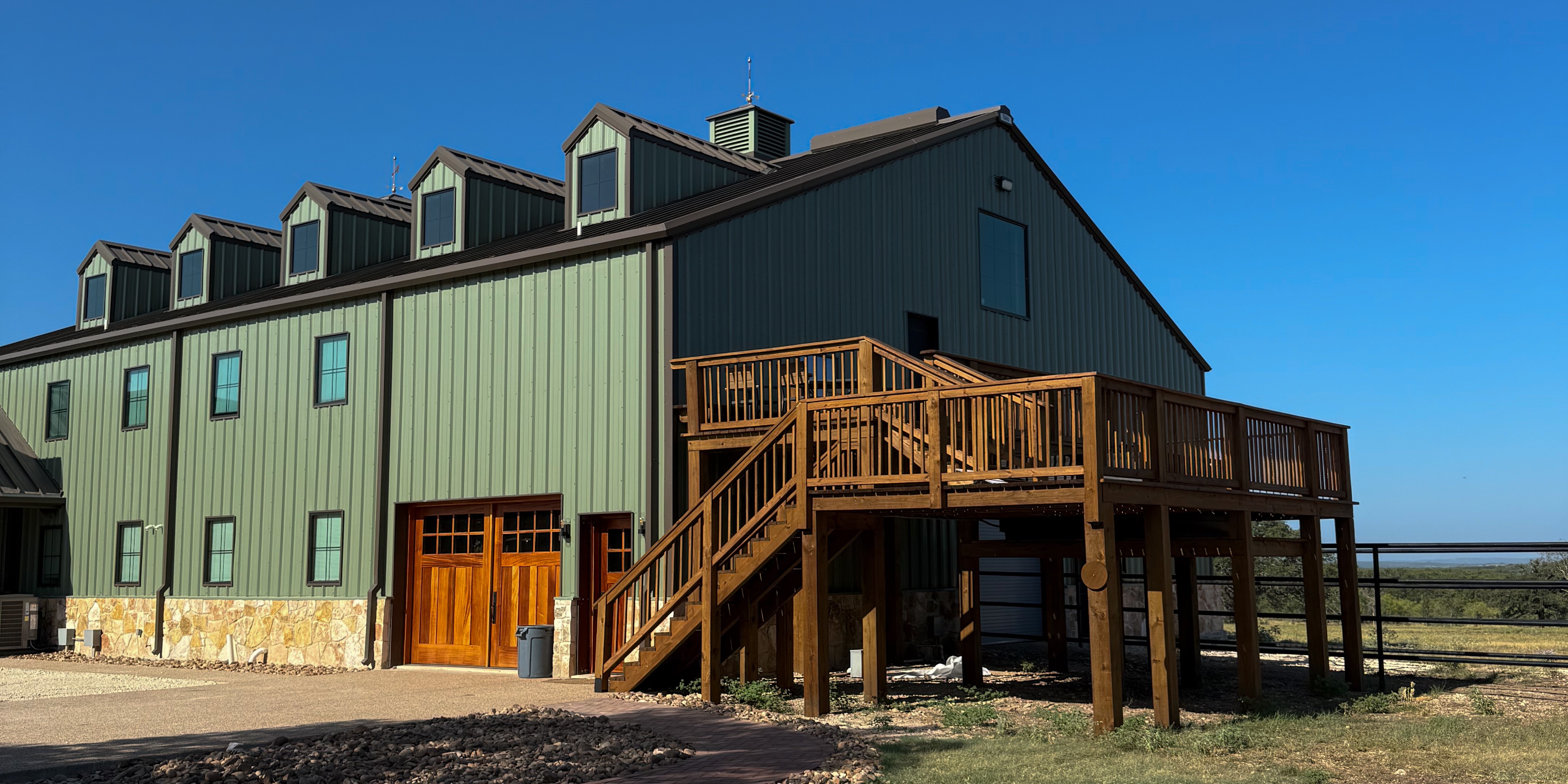Giraffe House at Artemis Ranch - green giraffe barn exterior with wraparound deck